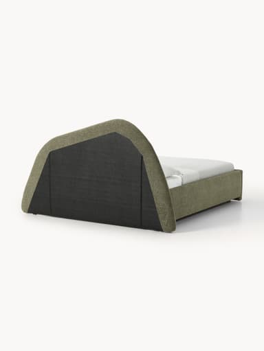 This is an image of a modern upholstered platform bed featuring a distinctive, large, and sculptural curved headboard. The bed frame and headboard are entirely covered in a textured, muted green/khaki fabric. The headboard curves upwards and then gently back, creating a visually interesting silhouette. The rear of the headboard appears to be finished in a darker, contrasting fabric or material. A white mattress and simple white bedding are visible on the bed frame. — 3D model