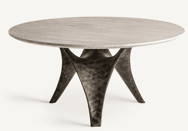 A round coffee table with a light-colored, textured stone or composite top and a unique, sculptural base. The base features multiple curved, organic-shaped legs that twist and converge towards the center, creating a dynamic and artistic silhouette. The finish on the base appears metallic with variations in tone, suggesting a patinated or distressed metal. — 3D model