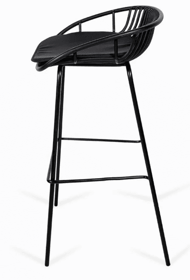 A contemporary bar stool featuring a black powder-coated metal wireframe bucket seat and backrest, paired with a fitted black padded seat cushion. The stool stands on four slender, tapered metal legs with integrated footrests, all finished in a matching matte black. — 3D model
