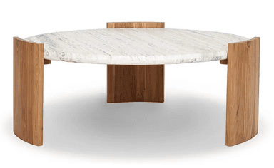 A contemporary round coffee table featuring a substantial marble top with prominent veining and a unique, curved wooden base. The tabletop appears to be made of natural stone, possibly travertine or marble, exhibiting a creamy white base with grey and beige striations. The base is constructed from solid wood, with four curved, quarter-circle-like panels that support the circular top and create an open, airy aesthetic. The wood grain is clearly visible, suggesting a natural finish. The overall design is sculptural and modern, blending natural materials for a sophisticated yet grounded appearance. — 3D model