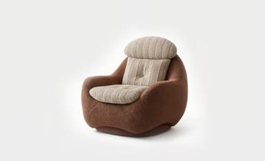 A contemporary lounge chair featuring a distinctive rounded and low-profile silhouette. The main body is upholstered in a textured, brown bouclé fabric, offering a plush appearance. It includes separate, striped cushions for the back and seat, with the seat cushion featuring a single central button tuft. The chair's design emphasizes comfort and a sculptural, organic form. — 3D model