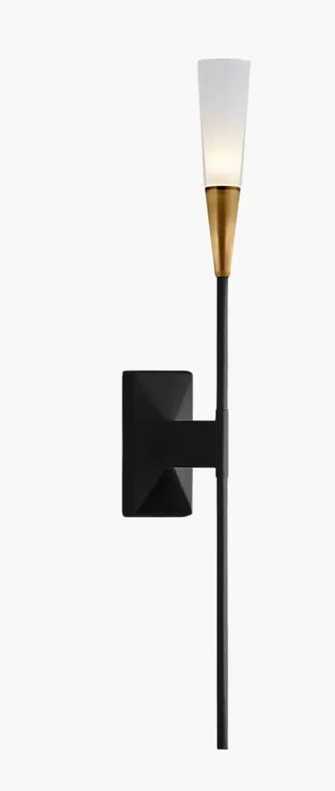 A modern wall sconce featuring a matte black, geometric wall mount that extends to a slender vertical rod. The rod culminates in a conical, brushed brass fixture supporting a frosted white glass shade that tapers upwards, emitting a warm light. — 3D model