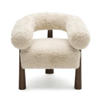 A plush, cream-colored armchair with a rounded, sculptural backrest and arms, upholstered in a shaggy faux fur. The chair is supported by four dark brown, tapered wooden legs that flare slightly outwards. Dimensions are indicated: 31.9"H x 31.2"W x 28.4"D, with seat height at 20.5"H. — 3D model