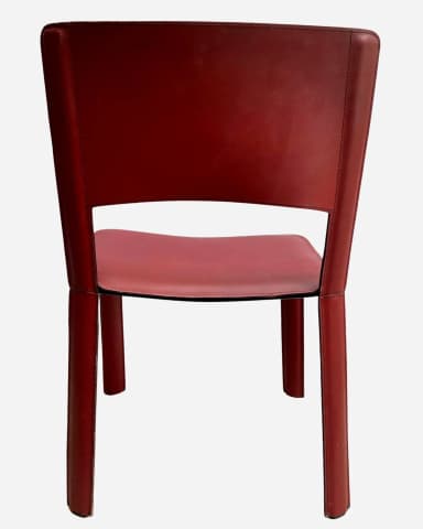 A modern side chair upholstered in red leather. The chair features a minimalist design with a continuous seat and backrest that forms integrated legs. The upholstery is stitched along the edges, creating a clean, tailored appearance. The backrest has a cutout at the top center. — 3D model