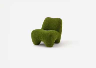 A low-slung, green, organic shaped lounge chair, entirely upholstered in a textured boucle fabric with a sculptural form, devoid of visible legs or distinct base. — 3D model