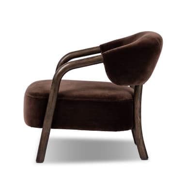 An upholstered armchair featuring a barrel-back design with exposed dark wood frame and dark brown velvet upholstery. — 3D model