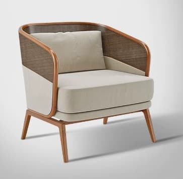 A contemporary armchair with a rounded, barrel-shaped back and armrests. The frame appears to be constructed from bent wood, possibly rattan or a similar material, with woven cane detailing on the upper sides of the backrest. The seat and back cushion are upholstered in a light-colored fabric. The chair is supported by four tapered wooden legs. — 3D model