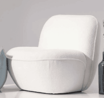 A modern armchair with a distinctive, rounded, and organic form. The chair features a plush, upholstered seat and backrest with no visible frame. Its silhouette is soft and inviting, designed for comfort and visual appeal. The armrests are integrated into the overall shape, providing a continuous flow. — 3D model