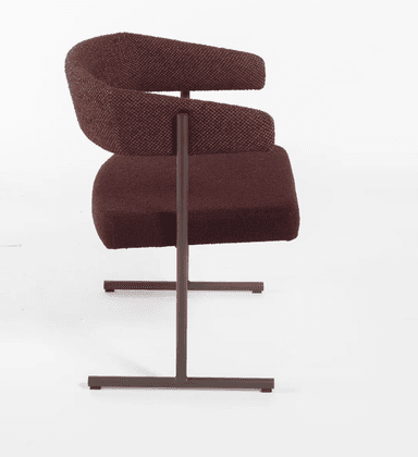 A modern upholstered armchair featuring a distinctive curved backrest that seamlessly transitions into armrests. The chair is supported by a minimalist dark brown metal sled base, giving it a contemporary floating appearance. The seat and backrest are covered in a rich maroon or burgundy-colored textured fabric, possibly bouclé, providing both comfort and visual interest. The design is clean and architectural, emphasizing form and material. — 3D model