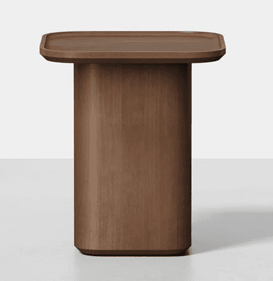 A modern end table with a rounded square top and a cylindrical pedestal base. The top has a slightly raised edge, resembling a tray. The entire piece is constructed from wood with a visible grain pattern. — 3D model