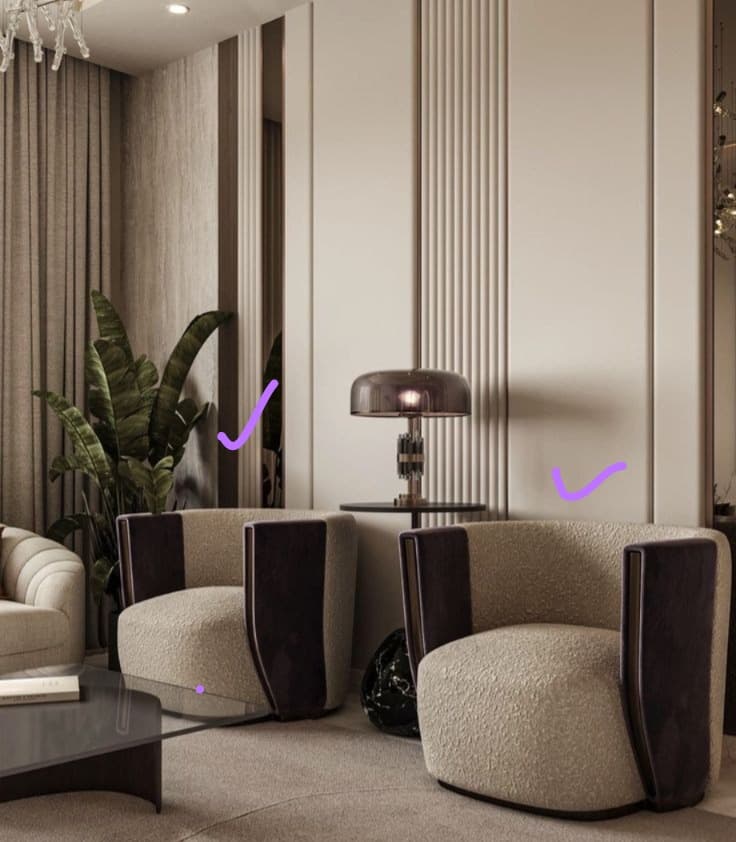 A contemporary barrel-shaped accent chair featuring a rounded back and seat, upholstered in a light, textured bouclé fabric. The chair incorporates distinct, curved armrests with dark, possibly lacquered wood or leather panels on the outer sides. It rests on a subtle, recessed dark base. — 3D model