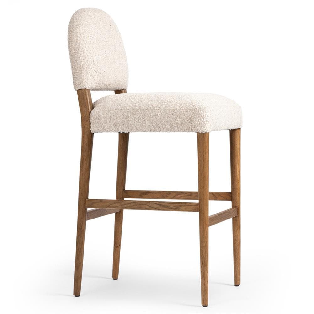 A contemporary bar stool featuring an off-white boucle upholstered seat and a rounded, upholstered backrest. The frame is constructed from light-colored wood, likely oak or ash, with four tapered legs and a rectangular footrest connecting the front and side legs. — 3D model