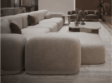 A contemporary modular sectional sofa featuring a low-profile design, upholstered in a light beige fabric. It comprises multiple rounded sections, including an L-shaped configuration with a chaise extension, and is accessorized with several smaller toss pillows in complementary beige and brown tones. — 3D model