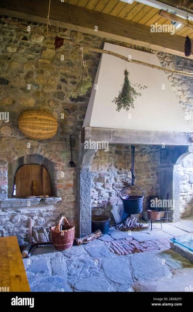 A high-resolution 3D render depicts a rustic stone fireplace with a prominent white plaster chimney hood. The fireplace features a substantial stacked stone surround with varying sizes and colors of natural stones, forming both the vertical structure and the integrated hearth. A heavy timber mantel shelf rests above the firebox opening, which is equipped with basic fire tools including a hanging pot and kindling. The overall design suggests a traditional or rural aesthetic. — 3D model