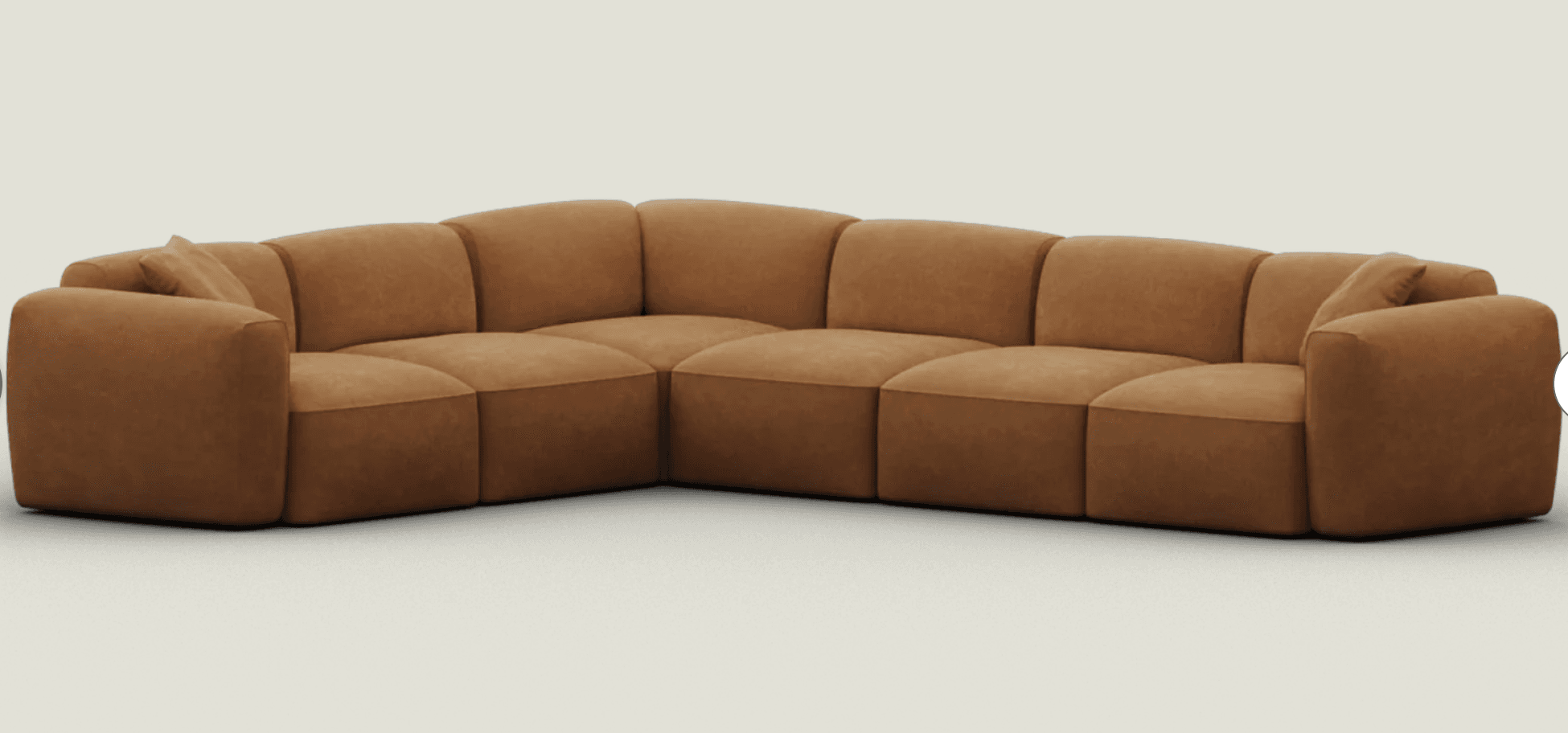 An L-shaped modular sectional sofa featuring a contemporary design with soft, rounded edges and a low profile. The sofa is upholstered in a rich, warm cognac brown fabric, possibly a suede or similar texture, with distinct stitching delineating each module. It comprises multiple individual sections that connect to form the corner configuration, offering ample seating. — 3D model