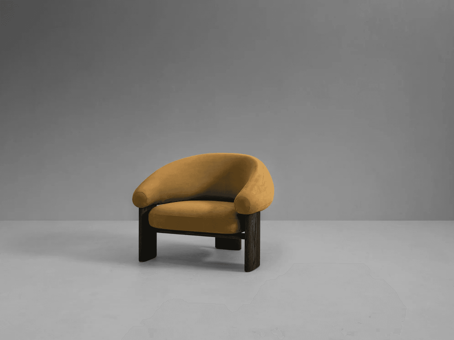 A contemporary armchair featuring a rounded, enveloping backrest and seat upholstered in a textured ochre fabric. The frame consists of robust, dark-stained wooden legs and a supporting structure that contrasts with the soft upholstery. The design combines organic curves with a strong, geometric base. — 3D model
