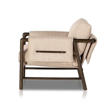 A modern lounge chair featuring an exposed dark-finished metal or wood frame supporting thick, light-beige fabric upholstery in a relaxed, sling-style design. The chair includes a padded backrest and seat cushion, with a horizontal bar detail visible on the rear securing the fabric. — 3D model