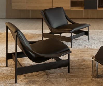 A modern lounge chair featuring a dark stained wooden frame with gracefully curved armrests and black upholstered seat and back cushions, designed for comfortable relaxation. — 3D model