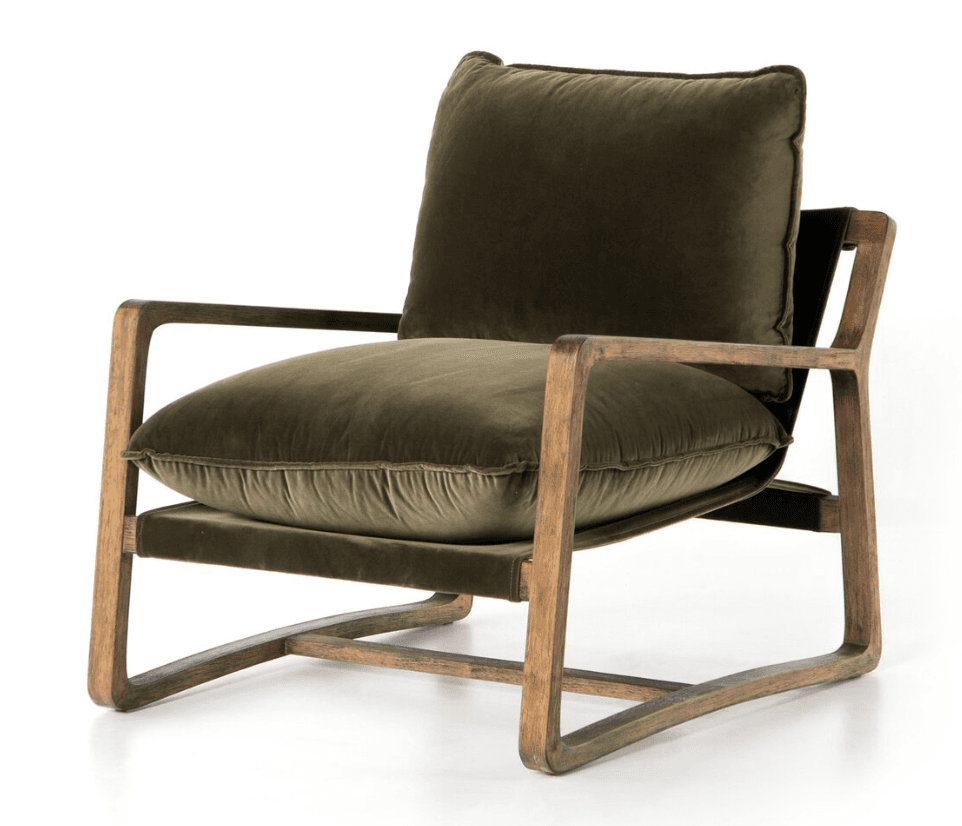 A modern lounge chair featuring a prominent open wooden frame in a natural finish, complemented by plush, dark green velvet cushions for the seat and backrest. The frame has gently curved armrests and a minimalist silhouette. — 3D model