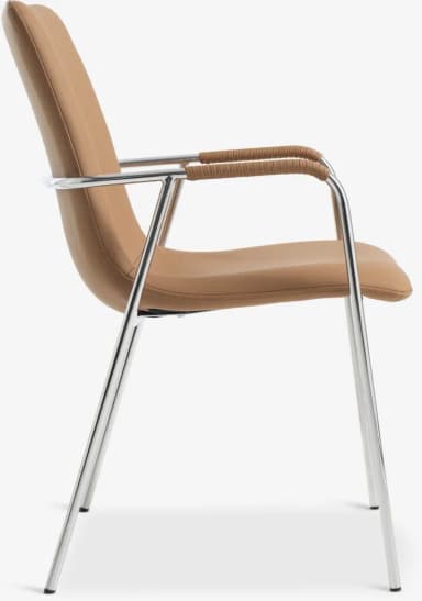 A contemporary armchair featuring a polished tubular chrome frame that forms the legs and integrated armrests. The seat and backrest are upholstered in a smooth, tan-colored material, likely faux leather or a durable fabric. The backrest is gently curved, contributing to the chair's sleek profile. — 3D model