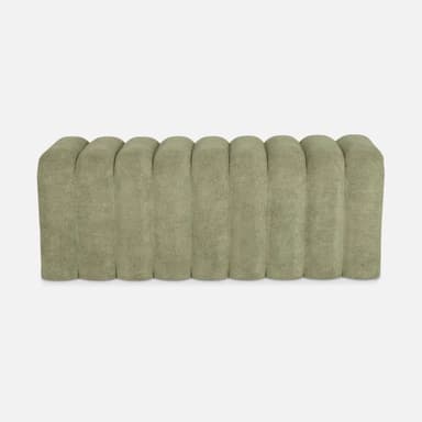 A plush bench with a channeled or fluted design. The piece features vertical, rounded channels across its surface, creating a consistent, textured aesthetic. It appears to be upholstered and has a low profile, suggesting it could be used for seating or as an ottoman. — 3D model