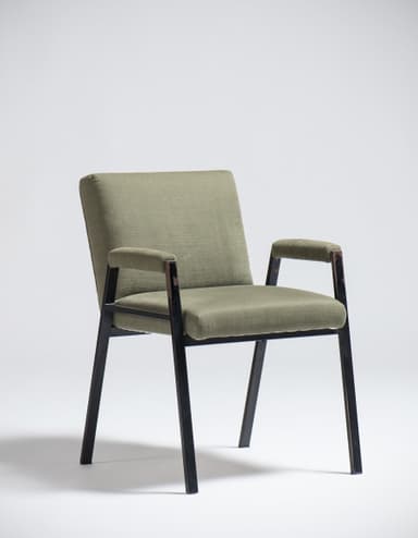 An armchair with a dark-colored frame and upholstered seat, back, and armrests in a light olive green fabric. The frame appears to be made of metal or a dark wood, with slender legs and arm supports. The upholstery has a textured weave. The design suggests a mid-century modern or contemporary aesthetic. — 3D model