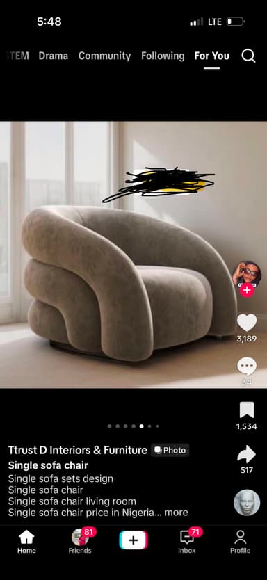 A contemporary single-seater lounge chair characterized by its unique, continuous, and rounded form. The chair is fully upholstered in a light beige or taupe textured fabric, presenting a soft, cloud-like aesthetic. Its design features thick, organic, and curvilinear lines that seamlessly integrate the back, arms, and seat into one voluminous shape. The base is minimally visible, contributing to a grounded yet seamless appearance. — 3D model