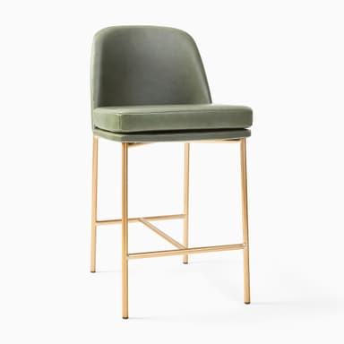 A contemporary bar stool featuring a comfortable green faux leather upholstered seat and backrest, supported by a slim, gold-finished metal frame with an integrated footrest. — 3D model
