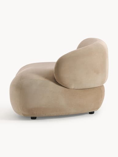 A contemporary armchair with a rounded, organic silhouette. It features a low profile with a deep seat and a single, curved armrest that seamlessly integrates into the backrest. The upholstery appears to be a soft, textured fabric. — 3D model