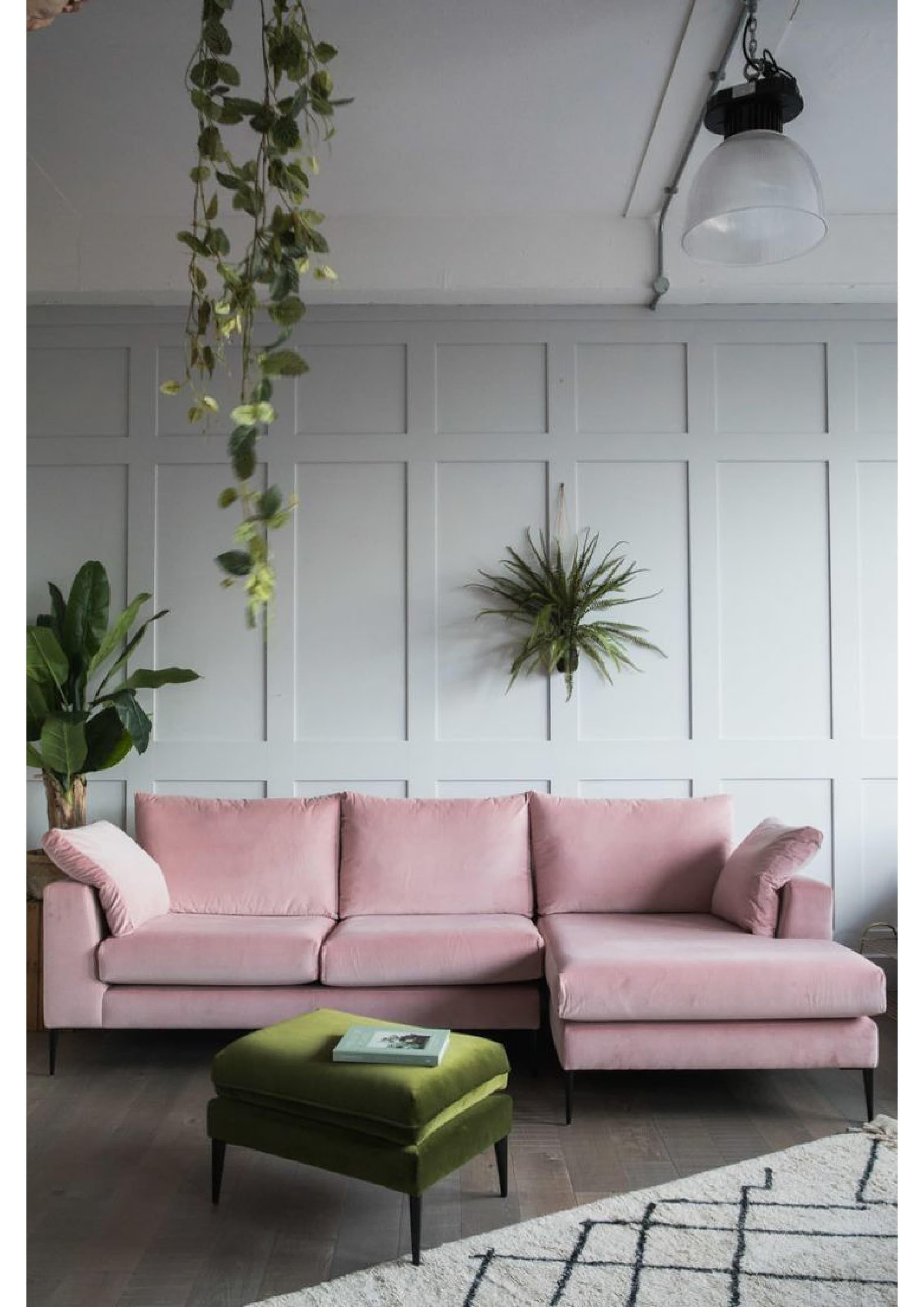 A modern L-shaped sectional sofa upholstered in pink velvet, featuring a chaise lounge extension, low arms, loose back cushions, and black metal tapered legs. — 3D model