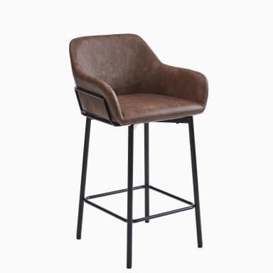 An industrial-style bar stool featuring a bucket-style seat upholstered in distressed brown faux leather with integrated armrests, set upon a matte black metal frame with four tapered legs and a square footrest. The seat is equipped with a swivel mechanism. — 3D model
