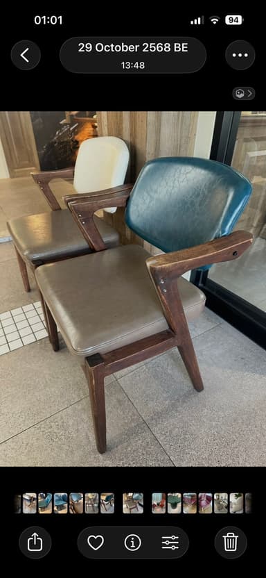 An armchair with a mid-century modern aesthetic, featuring a dark stained wooden frame and two-tone upholstery. The seat cushion is upholstered in a light grey material, while the curved backrest is upholstered in a contrasting teal or blue material. The wooden armrests are integrated into the frame, which consists of splayed legs and a clean, angular design. — 3D model