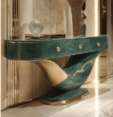 An elongated console table featuring a curved, sculptural base and an oval tabletop, finished in a dark emerald green marble-effect with striking gold-toned accents. It incorporates three discreet storage drawers with round brass pulls. — 3D model