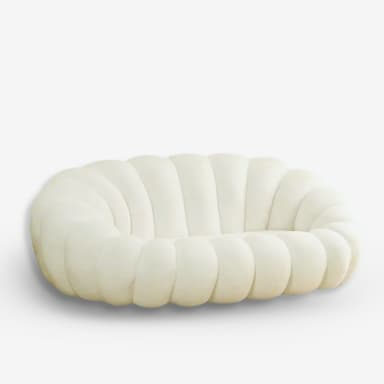A low-profile, cream-colored upholstered loveseat featuring a distinctive channeled or 'bubble' design. The seating unit consists of deeply cushioned, rounded segments that form the backrest, arms, and seat, creating a continuous, organic form. The absence of visible legs gives it a grounded appearance. — 3D model