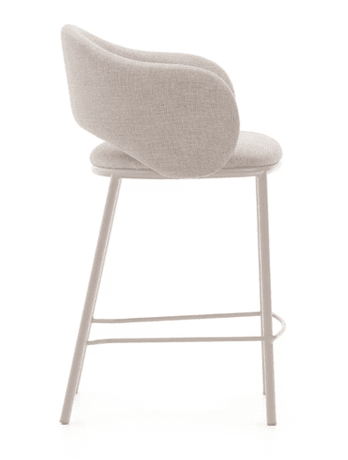 A contemporary bar stool featuring a fully upholstered seat and a curved backrest that subtly forms integrated armrests. The upholstery is a light beige, textured fabric. It is supported by four slender, straight metal legs that match the light color, and includes a circular metal footrest. — 3D model