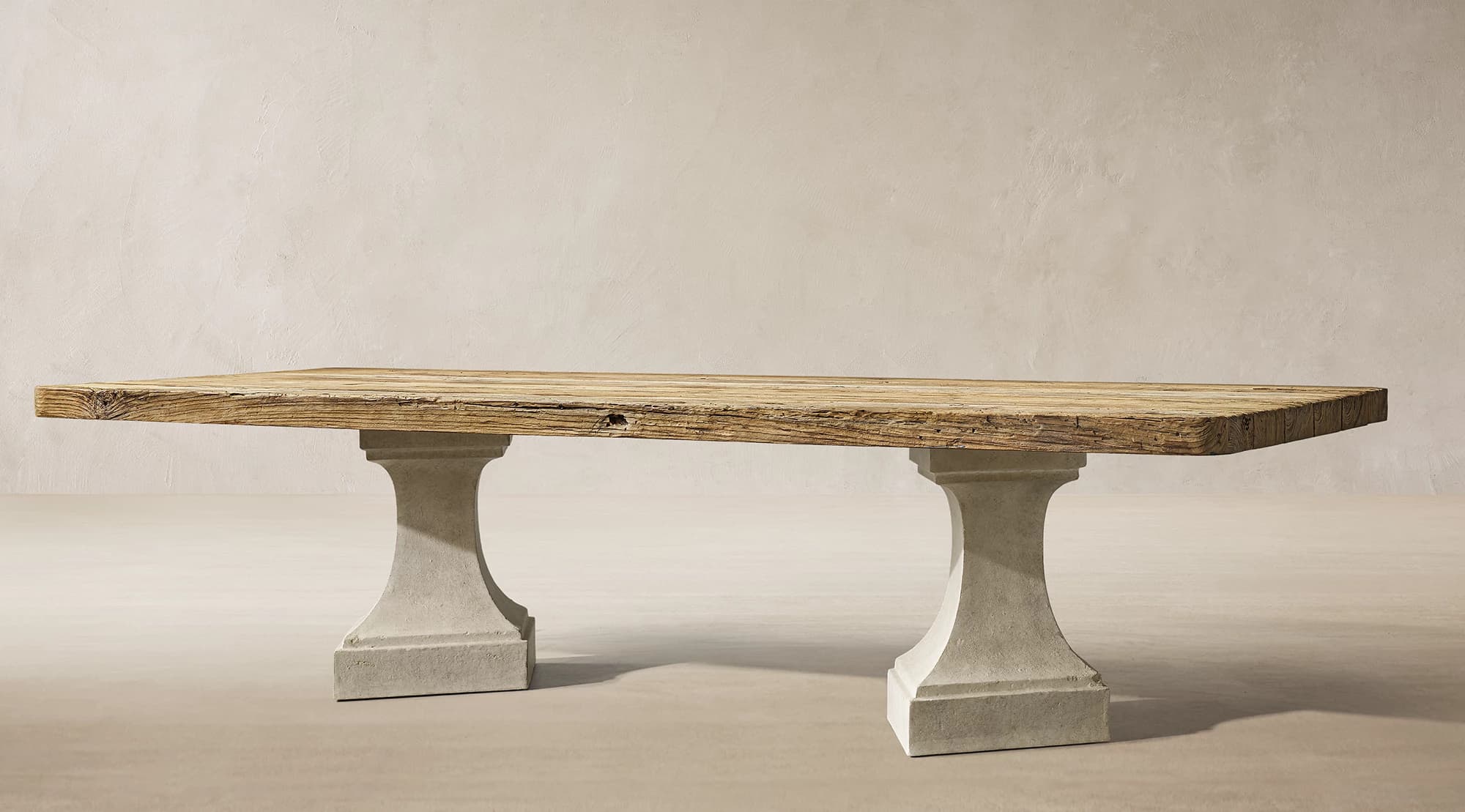 A rectangular dining table featuring a thick, distressed reclaimed wood plank top supported by two sturdy, light gray concrete pedestal bases. — 3D model