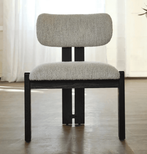 An armless upholstered chair with a light-colored, textured bouclé fabric on its seat and backrest, supported by a dark, possibly black or espresso-stained, rectangular wooden frame. — 3D model