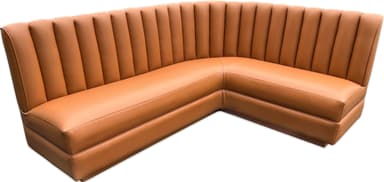 A corner booth-style seating unit with a fluted backrest and upholstered cushions. The unit is L-shaped, designed to accommodate multiple individuals. The upholstery features a consistent sheen, suggesting a synthetic leather or vinyl material. The design incorporates vertical channeling on the backrest and smooth surfaces on the seat and arms. — 3D model