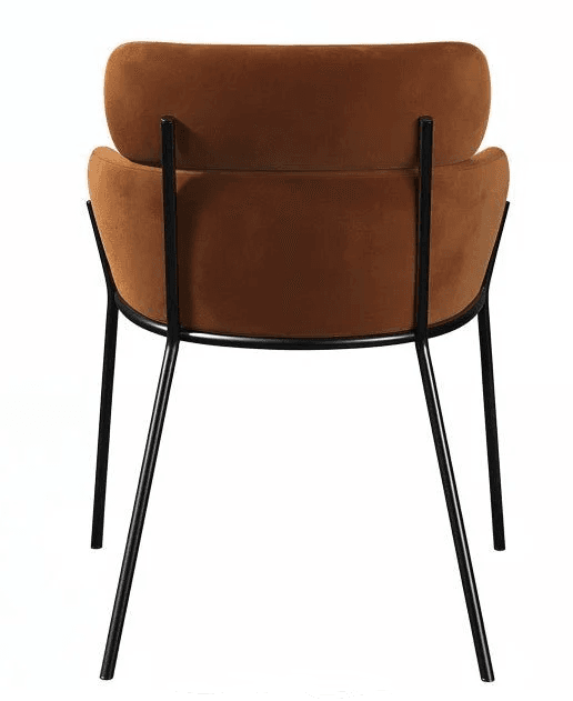 A modern dining chair featuring a rounded, padded seat and backrest upholstered in a rich rust-colored velvet or similar soft fabric. The seat and back appear as distinct, contoured elements. It is supported by a minimalist, four-legged black metal frame that extends upwards to secure the backrest, giving it a sleek and airy aesthetic. The legs are slender and angled, contributing to its contemporary design. — 3D model