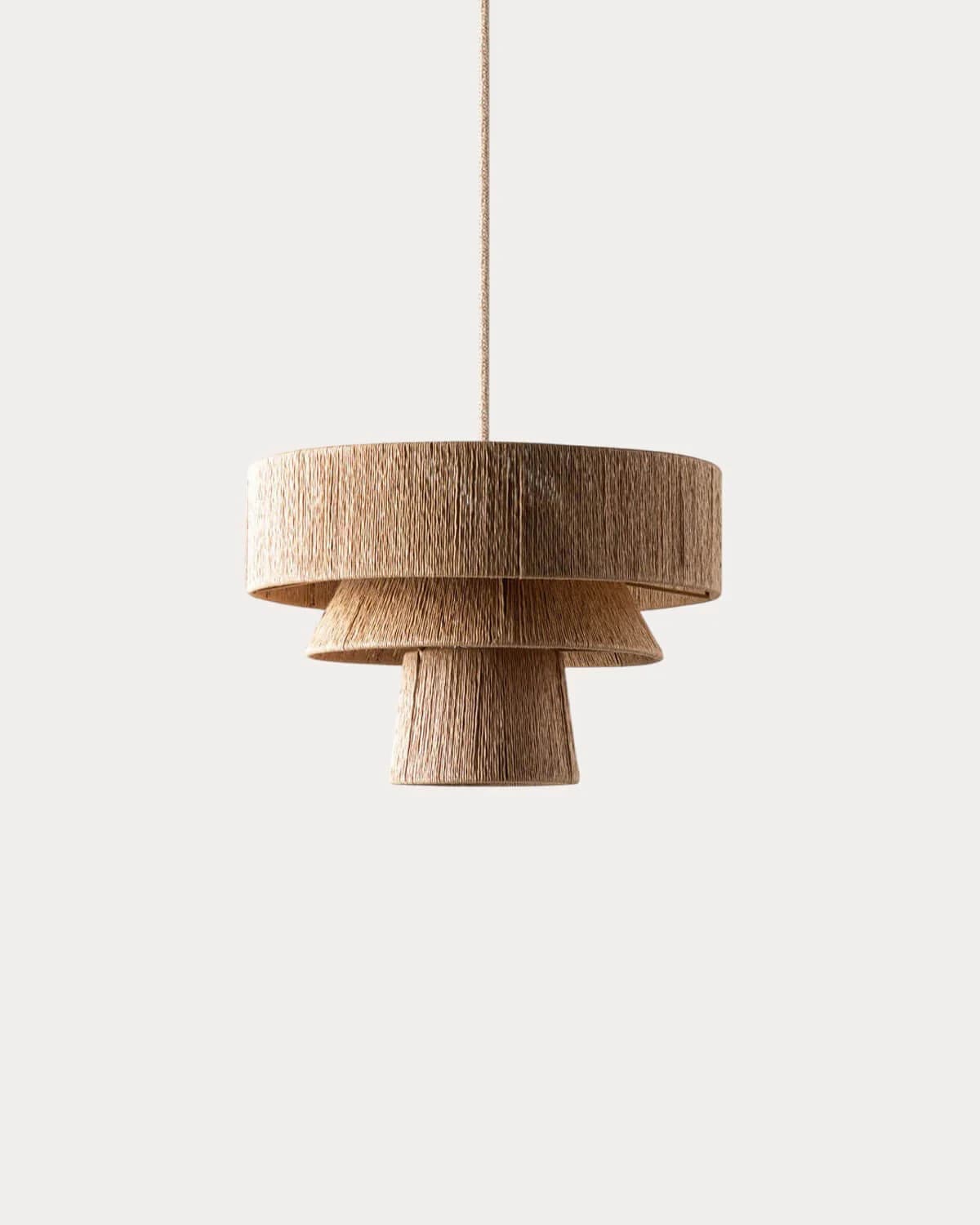 A tiered pendant light fixture featuring three stacked shades. The shades are cylindrical and vary in diameter, with the top shade being the widest and the bottom shade the narrowest. Each shade is constructed from tightly wound natural fiber material, creating a textured appearance. The fixture is suspended by a thin cord. — 3D model