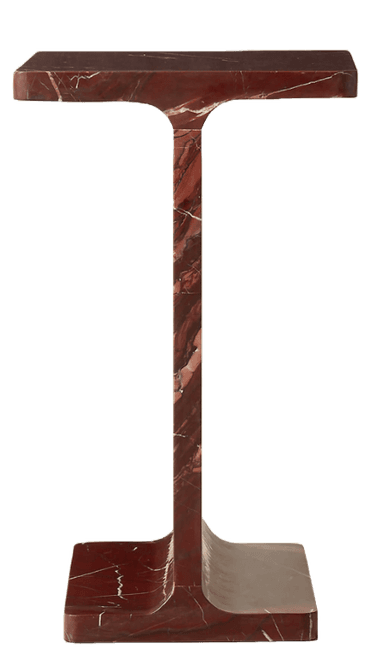 A monolithic pedestal table sculpted from red marble, featuring a flat rectangular top and base connected by a thick, central vertical support. The design is simple and geometric, with gently rounded edges where the vertical support meets the top and base. The marble exhibits prominent white and lighter red veining throughout its rich, dark red surface. — 3D model