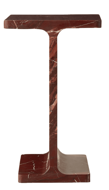 A monolithic pedestal table sculpted from red marble, featuring a flat rectangular top and base connected by a thick, central vertical support. The design is simple and geometric, with gently rounded edges where the vertical support meets the top and base. The marble exhibits prominent white and lighter red veining throughout its rich, dark red surface. — 3D model