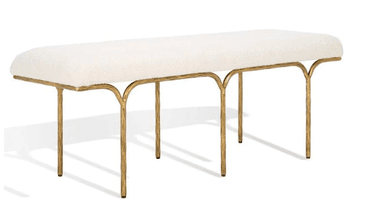 A long, upholstered bench with a rounded top and a slender, artistic metal base. The base features four legs that curve outwards from the underside of the seat, creating an open, sculptural form. The legs have a textured, organic appearance. — 3D model