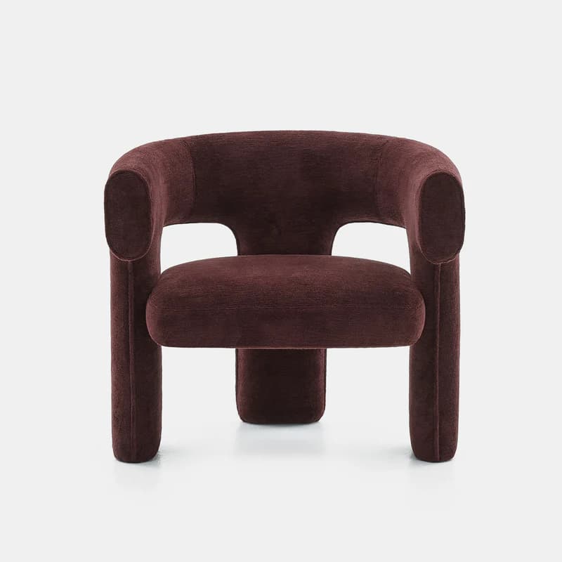 A modern, upholstered lounge chair featuring a distinctive sculptural and curvilinear form. The backrest and armrests are seamlessly integrated into a continuous, enveloping shape, upholstered in a deep reddish-brown, textured fabric. It stands on thick, rounded, integrated legs. — 3D model