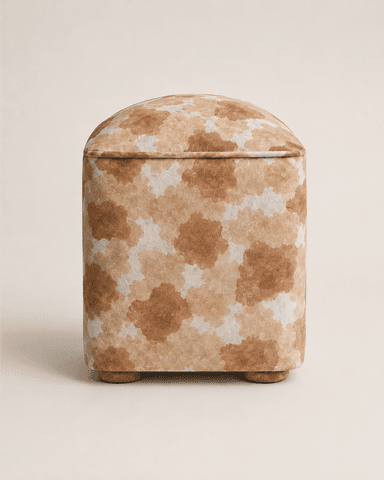 A square, upholstered ottoman featuring an abstract mottled pattern in shades of brown and beige, supported by small, discreet feet. — 3D model
