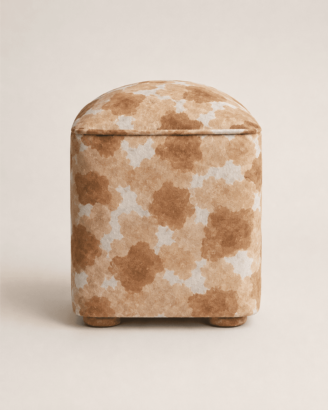 A square, upholstered ottoman featuring an abstract mottled pattern in shades of brown and beige, supported by small, discreet feet. — 3D model