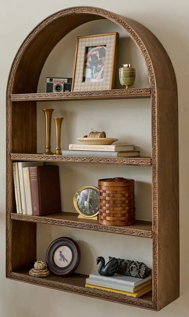 A freestanding bookcase with an arched top and four shelves. The bookcase features decorative molding along the top arch and the edges of each shelf. The wood grain is visible, suggesting a natural wood or wood veneer construction. — 3D model