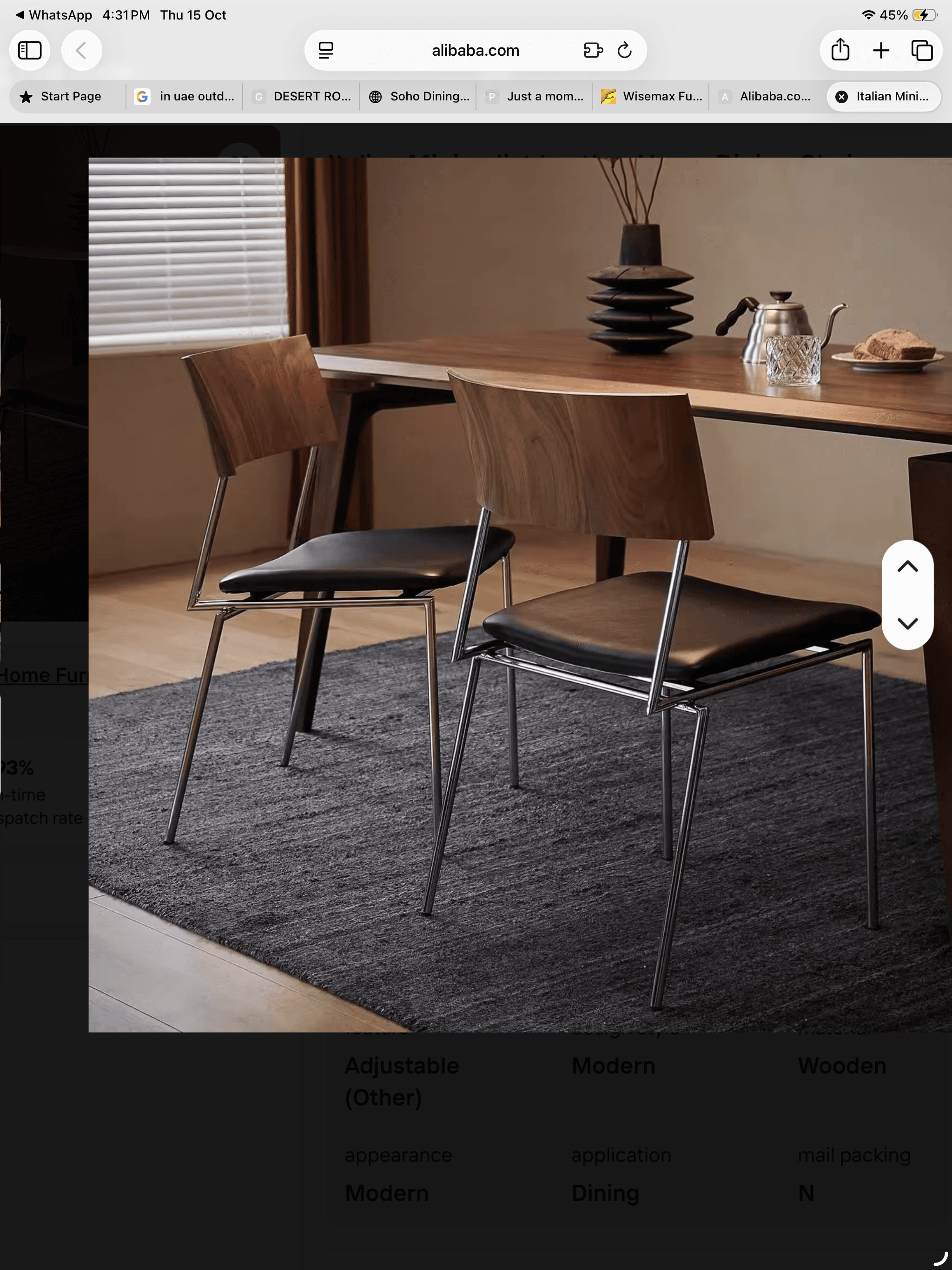 A contemporary dining chair featuring an armless design. It has a curved, dark wood (likely walnut plywood) backrest, a black upholstered seat, and a sleek four-legged frame made of chrome-plated metal. — 3D model