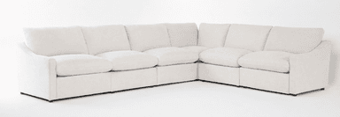 An off-white or cream-colored modular sectional sofa, configured in an L-shape. It features deep, plush seat cushions and backrests, giving it a soft and inviting appearance. The individual modules are upholstered in a light-colored fabric, likely linen or a similar texture. The design is contemporary with clean lines, subtly curved armrests, and low-profile dark feet that are minimally visible. — 3D model