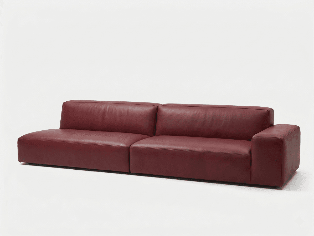 A modern, low-profile two-piece sectional sofa upholstered in deep red leather. It features clean lines, block-style armrest on one side, and backrests, with minimal visible legs, giving it a sleek, grounded appearance. The left module is armless, functioning like a chaise, while the right module has a single, wide armrest. — 3D model
